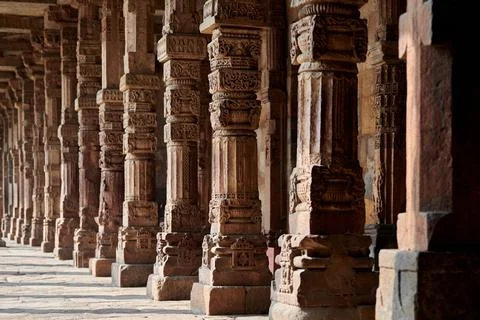 Stone columns with decorative bas relief of Qutb complex in South Delhi, In.. Stock Photos