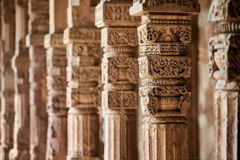 Stone columns with decorative bas relief of Qutb complex in South Delhi, In.. Stock Photos