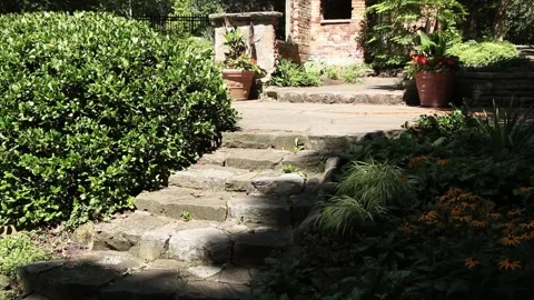 Stone concrete cement steps with small villa home house shed at top surrounded Stock Footage 249422222