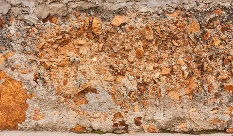 A stone, concrete wall in the section. Beautiful close-up background. Stock Photos