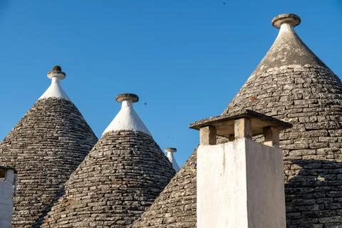 Stone conical roofs with whitewashed chimney in Alberobello Photos
