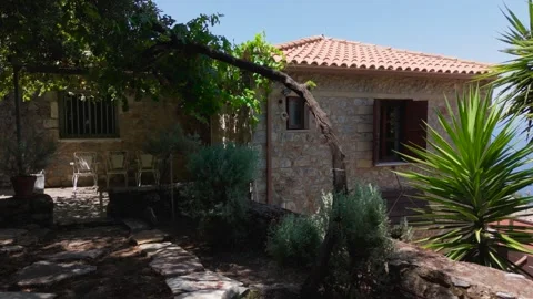 Stone Cottage Beneath Grapevine and Terracotta Roof Stock Footage 343915841