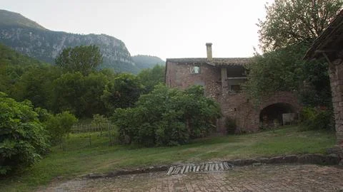Stone cottage in a mountain setting Stock Photos