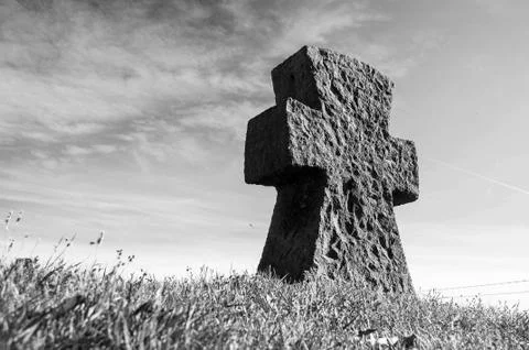 Stone cross on grass Stock Photos