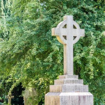 Stone cross on grave Stock Photos