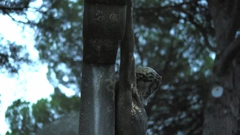Stone cross with Jesus located in an old cemetery Stock Footage 324753825