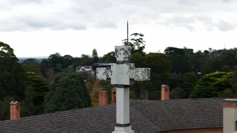 Stone cross monument overlooking cityscape and mountains Stock Footage 336760785