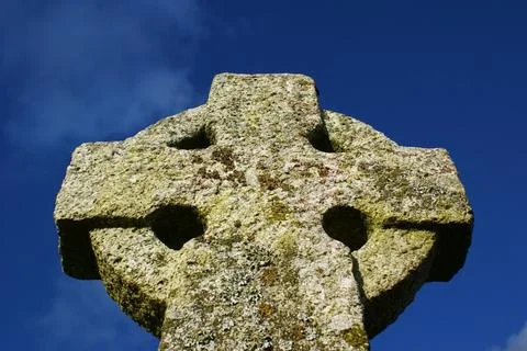 Stone cross. Old Celtic cross on sky background. Stock Photos