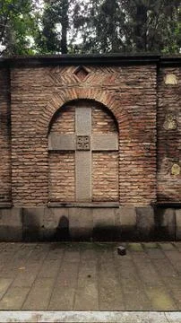 Stone cross set in old brick wall Stock Photos