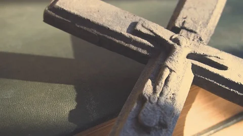 A stone cross on the top of a building - closeup - trees in the background Stock Footage 125533374