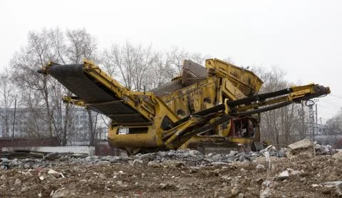 Stone crusher parked by the construction site Stock Photos