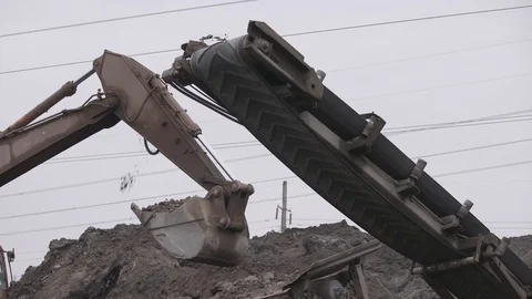 Stone crusher. Rock showered with loader belts in the quarry Stock Footage 99884334