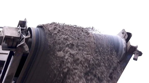 Stone crusher. Sand is poured from the loader belt in the quarry Stock Footage 99884337