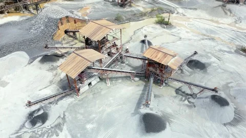 Stone crushing machine system at open pit mining quarry. Aerial drone shot Stock Footage 230675893