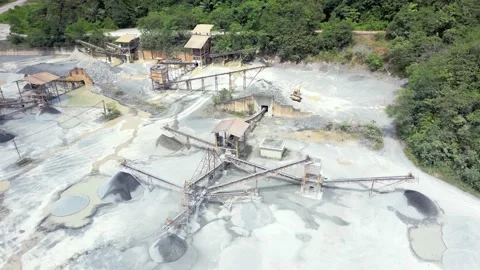 Stone crushing machine system at open pit mining quarry. Aerial drone shot Stock Footage 230677199