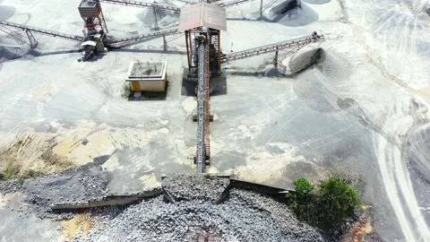 Stone crushing machine system at open pit mining quarry. Aerial drone shot Stock Footage
