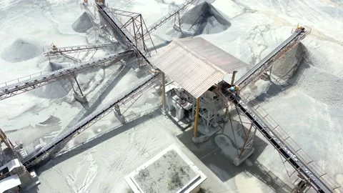 Stone crushing machine system at open pit mining quarry. Aerial drone shot Stock Footage 230749487