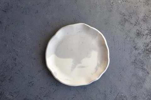 Stone curl gray platter on conrete table Stock-Fotos