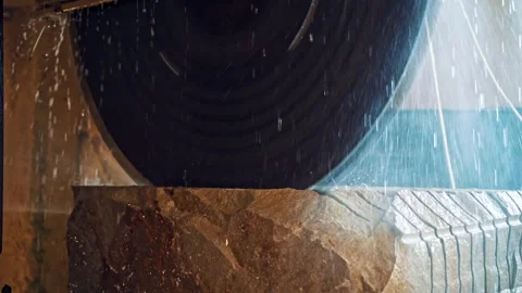 Stone cutting machine processing large granite block with water coolant mot.. Stock Footage 337545283