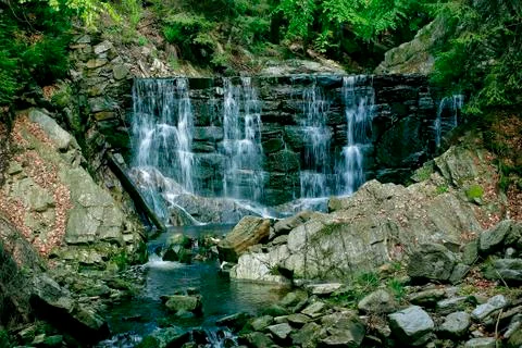 A stone dam on a mountain stream Stock Photos