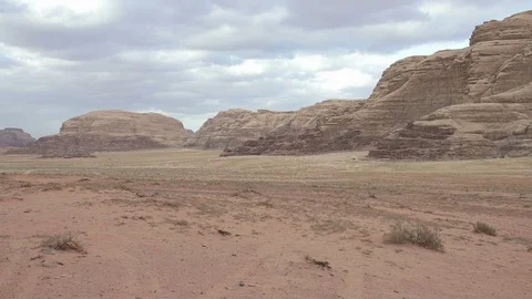 Stone desert landscape and cloudy sky. Red rocks and sand. Stock Footage 112868982