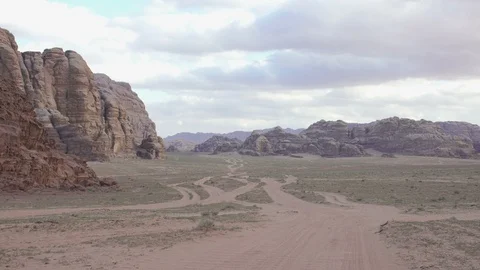 Stone desert landscape. Red rocks and sand and cloudy sky. Stock Footage 112861183