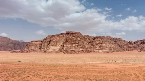 Stone desert landscape. White clouds move across the blue sky Stock Footage 108836316