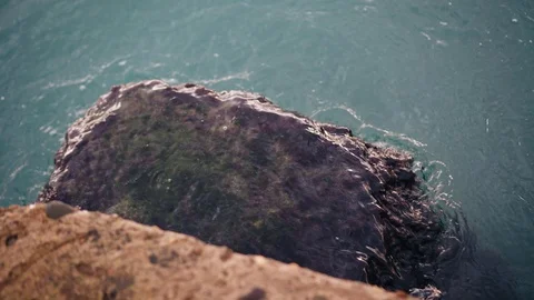 The stone on the dock is covered with moss. Water washes the stone beautifully Stock Footage 122435325