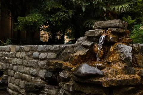 Stone drinking spring. Stock Photos