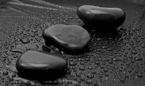 Stone in drops of water Stock Photos