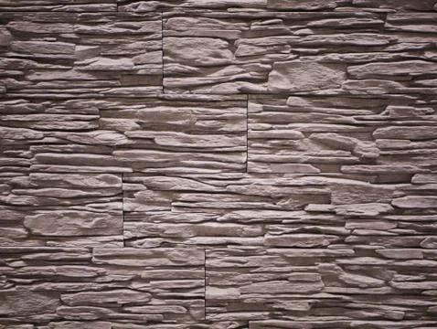 Stone facade close-up. Torn stone texture. Stone wall Stock Photos