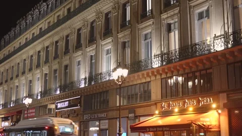 Stone facade with glowing windows and decorative balconies, Paris, France Stock Footage 337480237