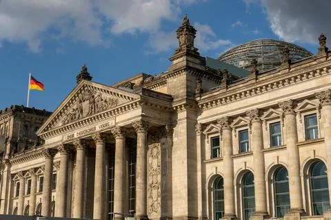 Stone facade of a grand classical building with columns and ornate carvings.. Stock Photos