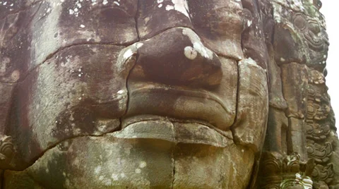 Stone face on the tower of the ancient temple. bayon, angkor, cambodia Stock Footage 34818681
