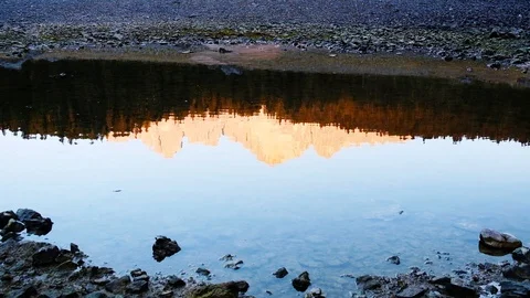 Stone falls into calm in Carezza lake water Stock Footage