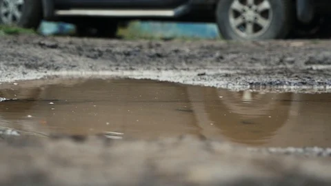 The stone falls into a puddle Stock Footage 117178674