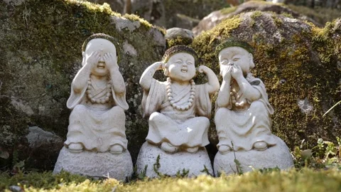Stone figures of buddha acting like three wise monkeys Mizaru, Kikazaru, Iwazaru Video stock 182132504