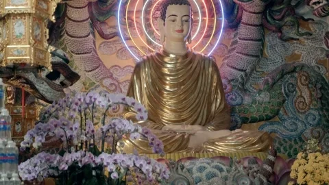 Stone figures of dragons surround a golden statue of the Buddha Stock-Footage 333353162
