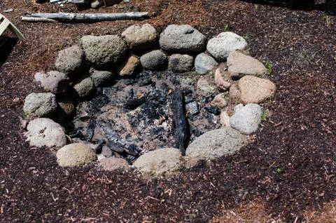 Stone firepit in the garden Stock Photos