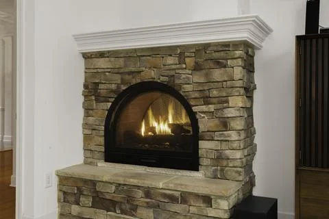 Stone Fireplace With Burning Fire In Modern And Cozy Living Space Interior. Stock Photos