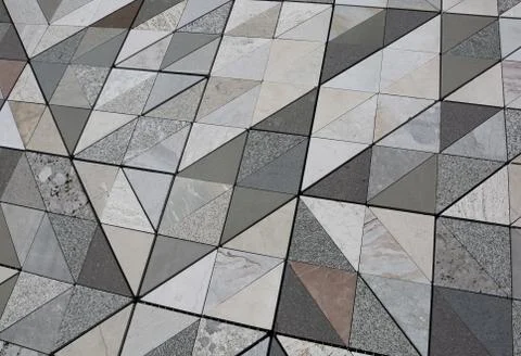 Stone floor with triangular shape each made with a different type of marble Stock Photos