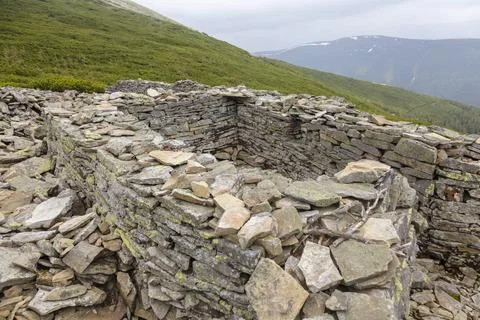 Stone fortification wall from the First World War covered with yellow moss,.. Foto stock