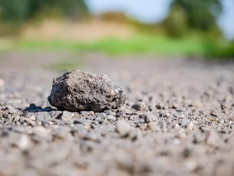 Stone freely resting on stone path in rural area Foto stock