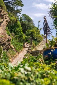 Stone Garden Path Through Lush Vegetation and Archway in Polperro Cornwall Stock Photos