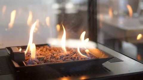 Stone gas fire pit with flames in modern fireplace in the restaurant 動画素材 98481539