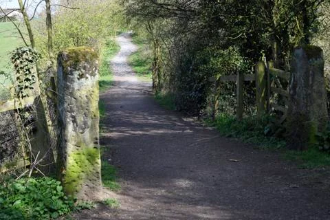 Stone gate posts on branch walkway Stock-Fotos