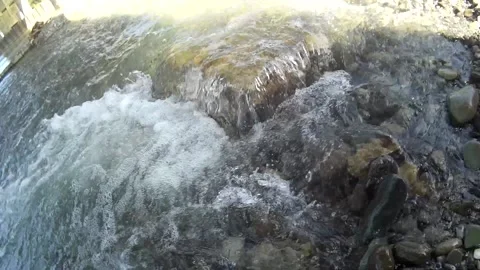 Stone glowing on River water with bubbles shining on the sun Stock Footage 146259457
