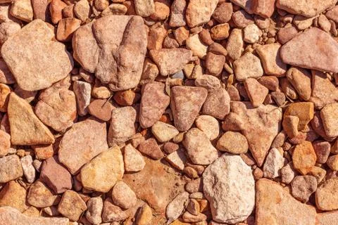 Stone ground texture. Umber mediterranean  stones on the ground. Stock Photos