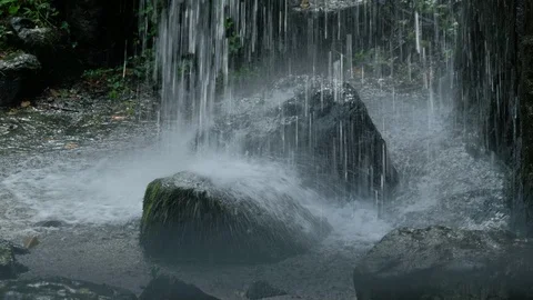 A stone that has been washed away by the waterfall 스톡 동영상 116441195