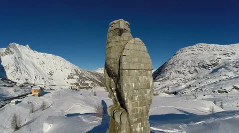 Stone hawk statue. snow winter landscape. mountains nature. sunset. aerial view Stock Footage 34543628